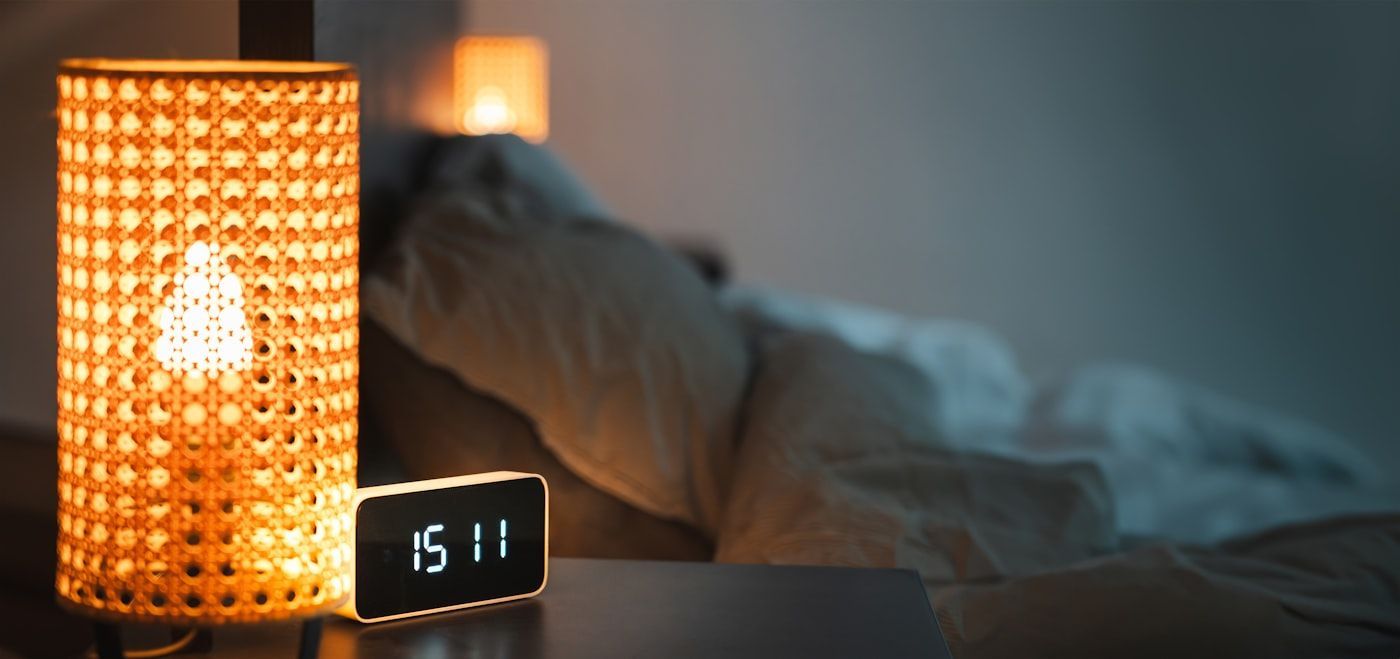 A clock on a bedside table during the night