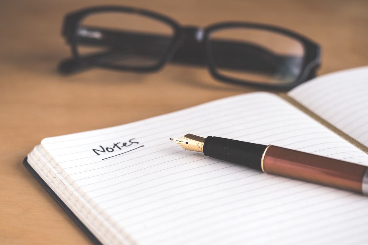 A notebook and planner on a desk, used for organisation